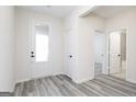 Bright entryway with gray flooring, white walls, and doors leading to various rooms in the home at 3382 Arabian Farm Ln, Dacula, GA 30019