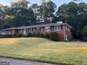 Charming brick home featuring a well-manicured lawn and mature shrubbery at 363 Seminole Drs, Marietta, GA 30060