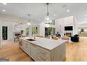 Open kitchen featuring a large island, modern appliances, and a view of the living area at 490 Mount Paran Rd, Atlanta, GA 30327