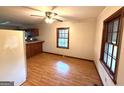 Cozy dining area featuring wood-look flooring, large windows, and a ceiling fan for added comfort at 359 Keys Ferry St, Mcdonough, GA 30253