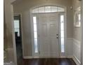 Bright foyer featuring a white front door with sidelights and transom window, and dark wood flooring at 4230 Vinca Way, Union City, GA 30291