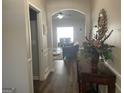 Hallway leading to a living area with archway, hardwood floors, and decorative accents on a console table at 4230 Vinca Way, Union City, GA 30291