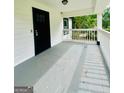 Spacious front porch features a secure entry door and ample space for outdoor seating at 2502 Barge Sw Rd, Atlanta, GA 30331