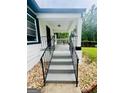 Inviting covered front porch with freshly painted stairs and elegant railings, enhancing curb appeal at 2502 Barge Sw Rd, Atlanta, GA 30331