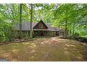 Charming home with lush green trees on a sunny day, complete with a quaint front yard at 9511 High Point Rd, Villa Rica, GA 30180