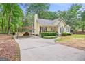 A view of a single-story home with manicured lawn, covered parking, and lush landscaping at 40 Green Leaf Cir, Hampton, GA 30228