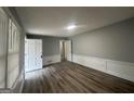 A versatile room featuring newly installed floors, fresh paint, and minimalist trim at 6982 Knollwood Dr, Morrow, GA 30260