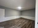 A versatile room featuring newly installed floors, fresh paint, and minimalist trim at 6982 Knollwood Dr, Morrow, GA 30260