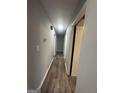Hallway with gray walls and wood flooring, leading to various rooms in the home at 6982 Knollwood Dr, Morrow, GA 30260