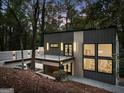 Modern home with gray siding, stylish lighting, balcony, and large windows offering abundant natural light at 1153 Dawn View Nw Ln, Atlanta, GA 30327