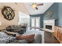 Open-concept living room with fireplace, hardwood floors, and view into the breakfast nook at 308 Dylan Way, Mcdonough, GA 30252