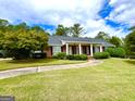 Well-maintained brick home featuring a lush lawn and a welcoming front entrance at 7963 Smith Rd, Villa Rica, GA 30180