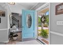 Inviting foyer with light blue door and tile flooring, leading to the staircase and entryway at 317 Calgary Dr, Peachtree City, GA 30269