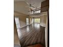 Bright living room boasts wood floors, vaulted ceiling and lots of natural light from large windows at 150 Riversong Dr, Alpharetta, GA 30022