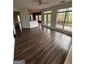 Inviting living room with wood floors and large windows offering scenic outdoor views at 150 Riversong Dr, Alpharetta, GA 30022