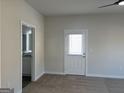 Light-filled bedroom showcasing plush carpeting, a ceiling fan, and an ensuite bathroom with a door to outside at 5322 Tolar Rd # 27, South Fulton, GA 30213