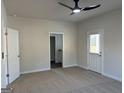Spacious bedroom showcasing plush carpeting, a ceiling fan, and an ensuite bathroom with a door to outside at 5322 Tolar Rd # 27, South Fulton, GA 30213