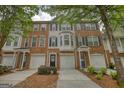 Charming townhouse exteriors featuring brick and siding, attached garages, and lovely landscaping for curb appeal at 2160 Dillard Xing, Tucker, GA 30084