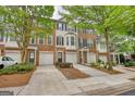 Exterior of townhomes boasting brick facades, integrated garages, and manicured lawns for appealing curb appeal at 2160 Dillard Xing, Tucker, GA 30084