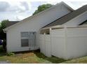 View of the backyard, featuring a privacy fence, grass and the side of the house at 214 Oak Cir, Stockbridge, GA 30281