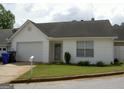 Single-story home featuring a one car garage, manicured lawn, and welcoming entrance at 214 Oak Cir, Stockbridge, GA 30281