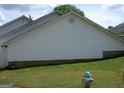 Showing the side of the house with vinyl siding and a gas connection point at 214 Oak Cir, Stockbridge, GA 30281