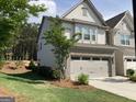 Well-maintained home featuring lush lawn, brick accents and a two-car garage at 6398 Lanier Harbor Lndg, Buford, GA 30518