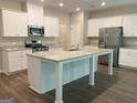 The kitchen features granite countertops, stainless steel appliances, and a large island at 6398 Lanier Harbor Lndg, Buford, GA 30518