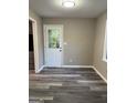 Room showcasing gray floors, a white door with glass panel, and neutral wall paint at 554 Windsor Dr, Forest Park, GA 30297