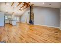 Spacious living room featuring hardwood floors, vaulted ceilings, and exposed wood beams and a fireplace at 4979 Snook Thompson Se Rd, Oxford, GA 30054