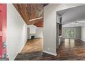 Open-concept entryway showcasing hardwood floors, wood ceiling, and living spaces at 3863 Dundee Ne Dr, Roswell, GA 30075