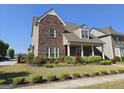 Lovely brick home with manicured landscaping and a welcoming covered porch at 101 Eadestowne Way, Peachtree City, GA 30269