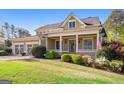 Attractive home with a welcoming front porch, a well-manicured lawn, and beautiful landscaping at 237 Highcrest Dr, Acworth, GA 30101