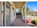 Inviting front porch with brick flooring, white columns, and a cozy atmosphere at 237 Highcrest Dr, Acworth, GA 30101