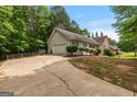 Long driveway leading to a charming ranch home with an attached garage at 372 River Point Dr, Mcdonough, GA 30252