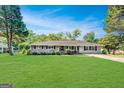 Well-manicured lawn and landscaping enhance this attractive single-story brick home at 5327 David Se Cir, Covington, GA 30014