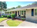Inviting front porch with neutral chairs, walkway, and attractive landscaping create a welcoming entrance at 5327 David Se Cir, Covington, GA 30014