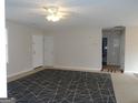 The spacious living room features neutral walls and carpet, with ample natural light at 56-1 N East Main St, Hampton, GA 30228