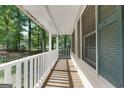 Long, covered front porch offers a relaxing space to enjoy the view at 632 Cloudland Dr, Stockbridge, GA 30281