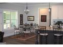 Eat-in kitchen with an adjacent dining area featuring iron chairs and a glass table at 808 Covered Bridge Rd, Covington, GA 30016