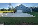 Long paved driveway leads to a rear entry two-car garage at 808 Covered Bridge Rd, Covington, GA 30016