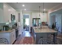 Spacious open kitchen with white cabinets, granite countertops and stainless appliances at 808 Covered Bridge Rd, Covington, GA 30016