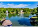 Scenic aerial view of the lakefront property, showing the water, dock, and surrounding lush greenery at 1295 Heritage Dr, Villa Rica, GA 30180