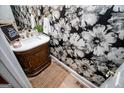 Stylish powder room featuring floral wallpaper, modern vanity, and elegant decor at 1295 Heritage Dr, Villa Rica, GA 30180