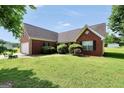 Classic brick home featuring shuttered windows and lush landscaping on a sunny day at 502 Gallantry Trl, Mcdonough, GA 30252