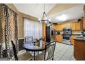 Eat-in kitchen features stainless steel appliances, and a granite topped table near a window at 502 Gallantry Trl, Mcdonough, GA 30252