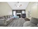 Cozy living room with a fireplace, a ceiling fan, and comfortable seating at 502 Gallantry Trl, Mcdonough, GA 30252