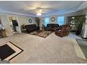 Spacious living room features a ceiling fan, carpet floors and ample natural light at 110 Kari Glen Way, Fayetteville, GA 30215
