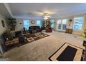 Spacious living room offers ample seating and natural light from the sliding glass doors at 110 Kari Glen Way, Fayetteville, GA 30215