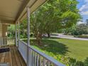 View from the covered front porch, showcasing the lush green lawn and neighborhood at 105 Birch Creek Cir, Mcdonough, GA 30253